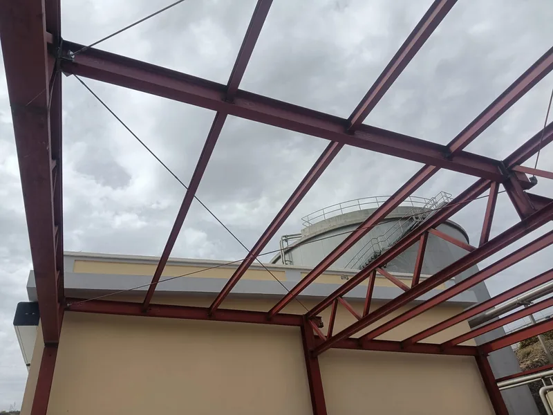 Detalle inferior de vigas, perfiles longitudinales y diagonales de una estructura metálica rojiza